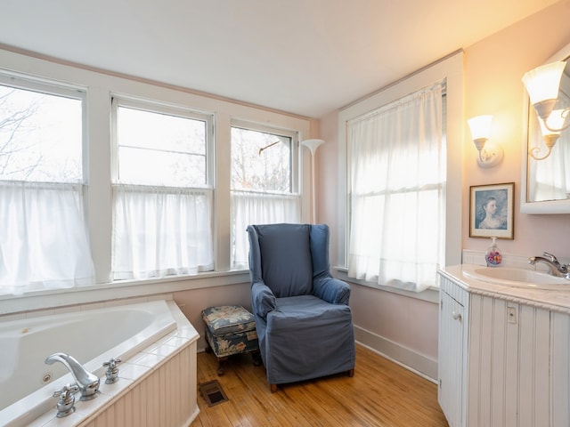 living area featuring light hardwood / wood-style flooring and sink