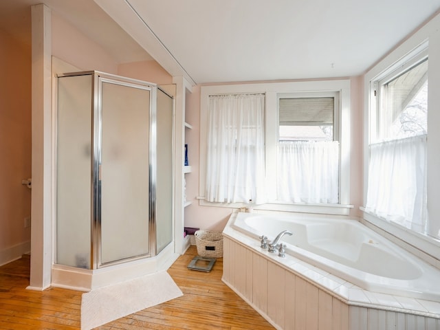 bathroom featuring hardwood / wood-style floors and independent shower and bath