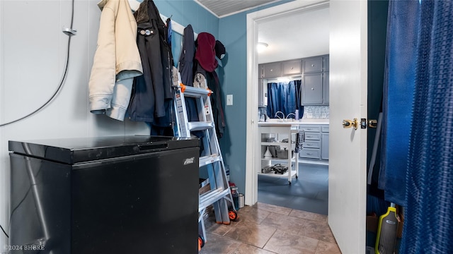 mudroom with dark tile patterned floors