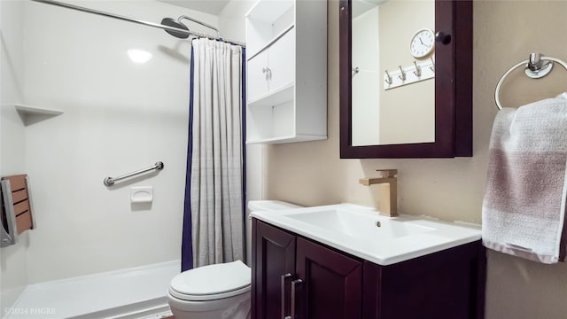 bathroom featuring curtained shower, toilet, and vanity