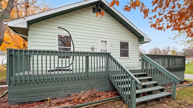 rear view of house featuring a deck