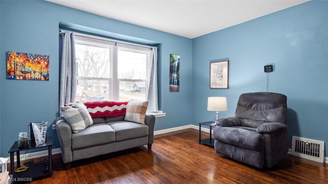 sitting room with dark wood-type flooring