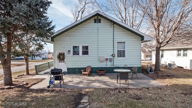 rear view of house featuring a patio and cooling unit