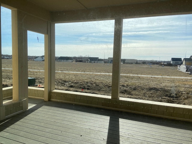 unfurnished sunroom featuring a rural view