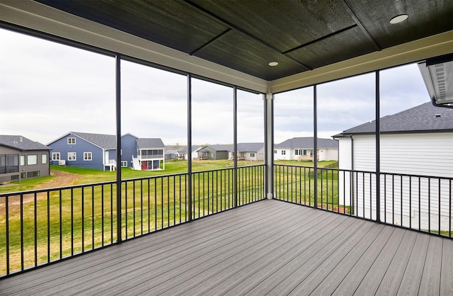 unfurnished sunroom featuring a residential view and plenty of natural light