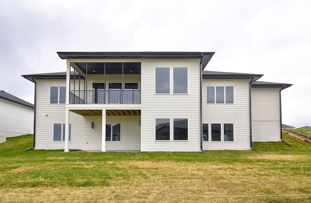 back of property featuring a yard and a balcony