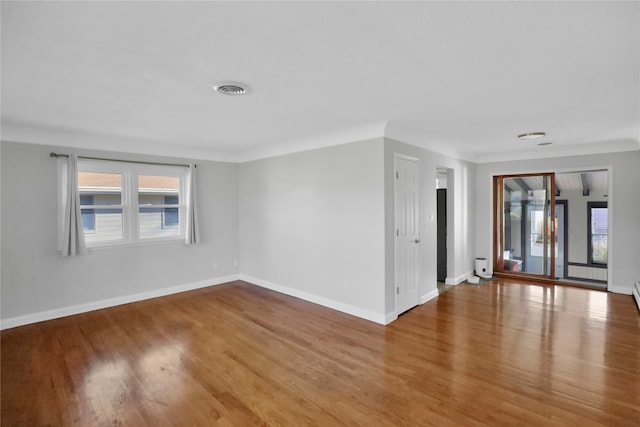 spare room with hardwood / wood-style floors