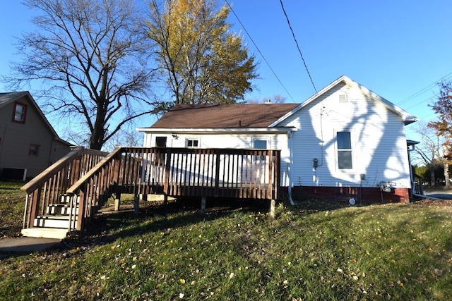 back of property with a lawn and a wooden deck