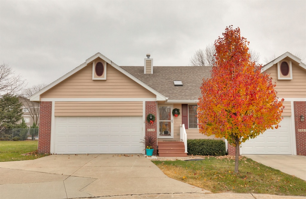 ranch-style home featuring a front yard and a garage