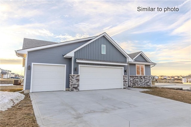 view of front of house featuring central AC and a garage