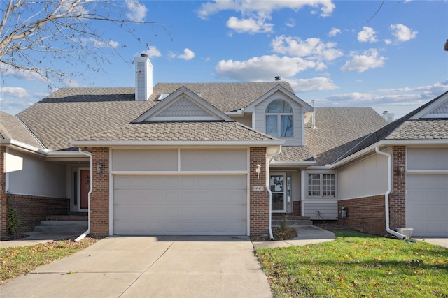 view of front of property with a garage and a front lawn