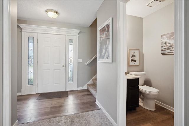 entrance foyer with hardwood / wood-style floors and a textured ceiling