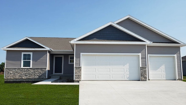 view of front of property with a garage and a front lawn