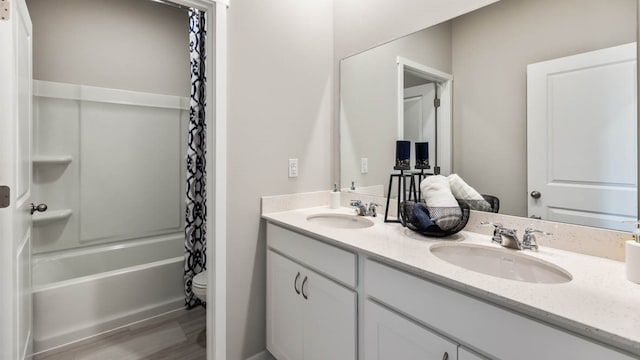 full bathroom featuring toilet, shower / bath combination with curtain, hardwood / wood-style floors, and vanity