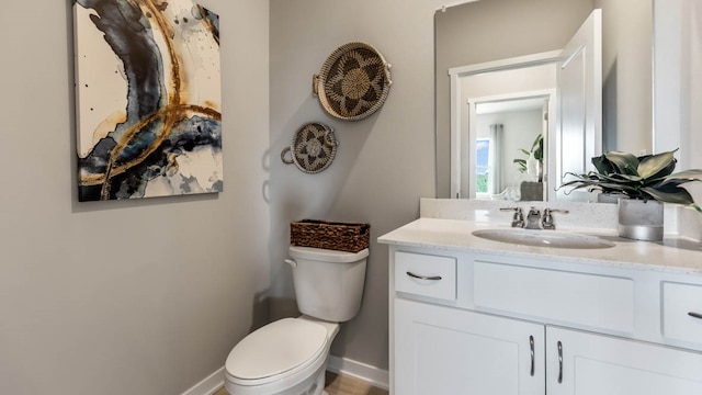 bathroom featuring toilet and vanity