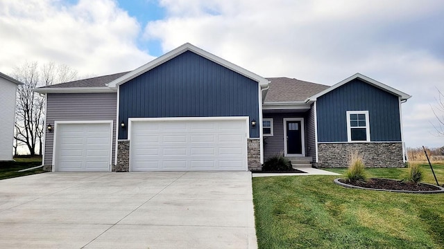 view of front of property featuring a garage and a front lawn