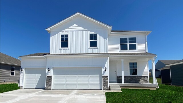 view of front of property with a front lawn and a garage