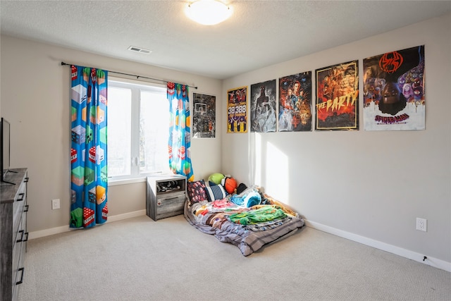 rec room with carpet and a textured ceiling