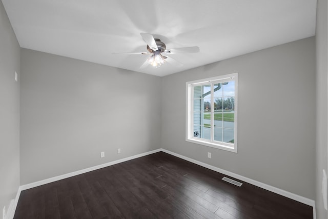 spare room featuring ceiling fan and dark hardwood / wood-style floors