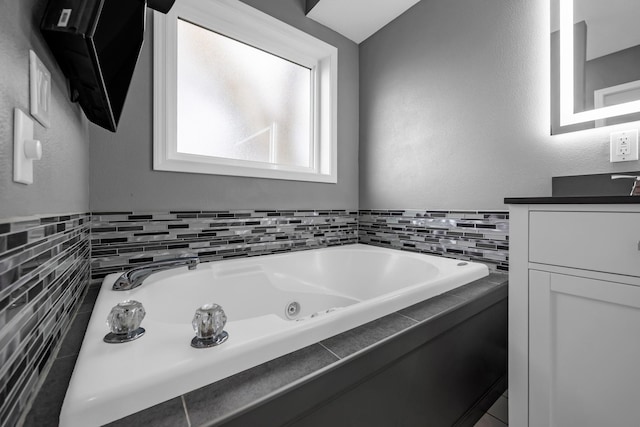 bathroom featuring vanity and a tub to relax in