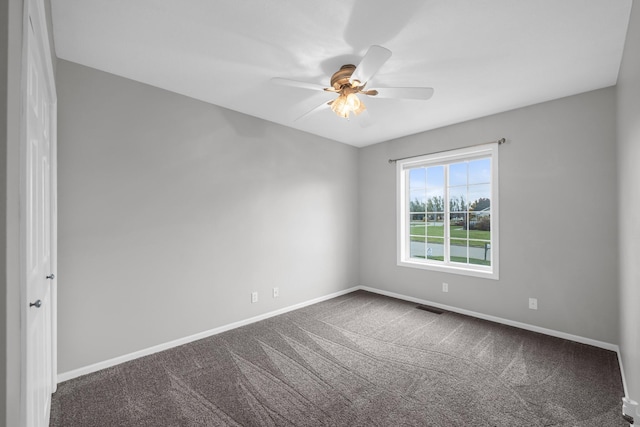 carpeted spare room with ceiling fan