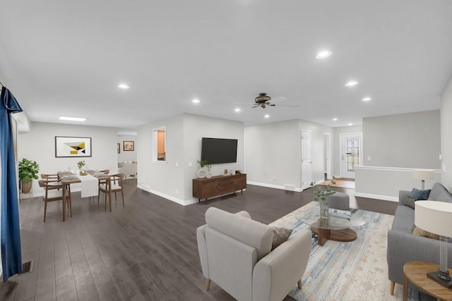 living room with ceiling fan and dark hardwood / wood-style floors