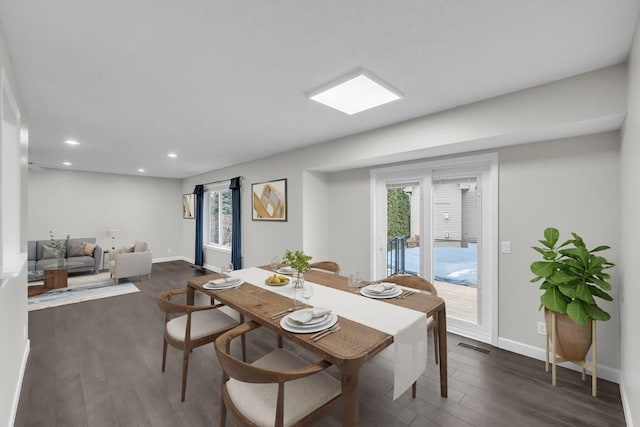 dining area featuring dark wood-type flooring