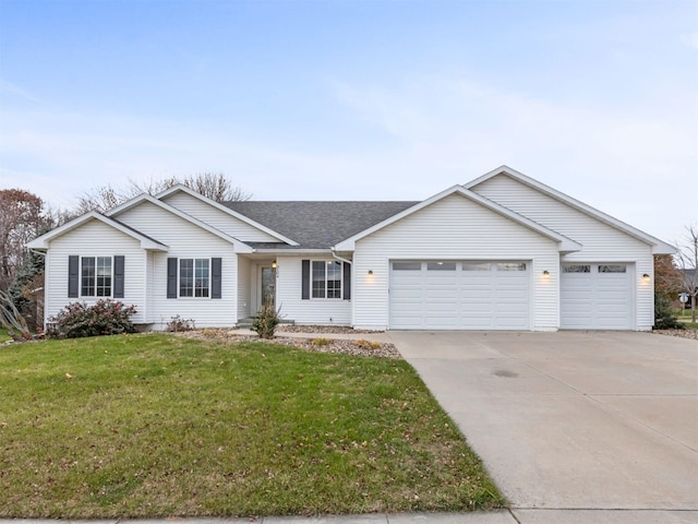 ranch-style house featuring a front yard and a garage