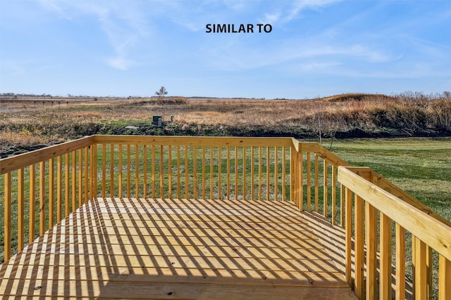 wooden terrace with a lawn and a rural view