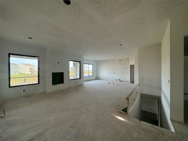 unfurnished living room featuring a textured ceiling