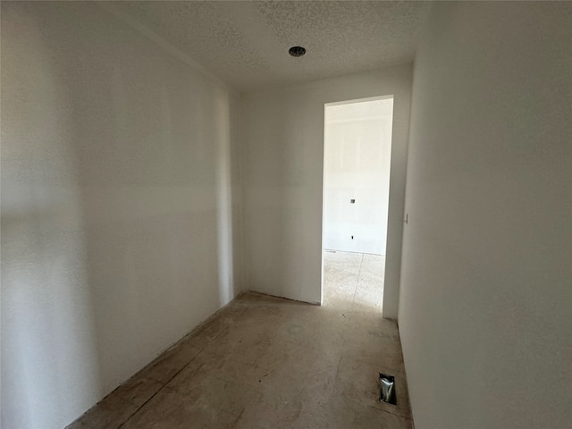 hall featuring a textured ceiling