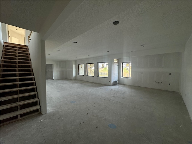 unfurnished living room featuring a textured ceiling