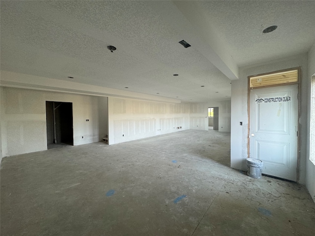 unfurnished living room with a textured ceiling