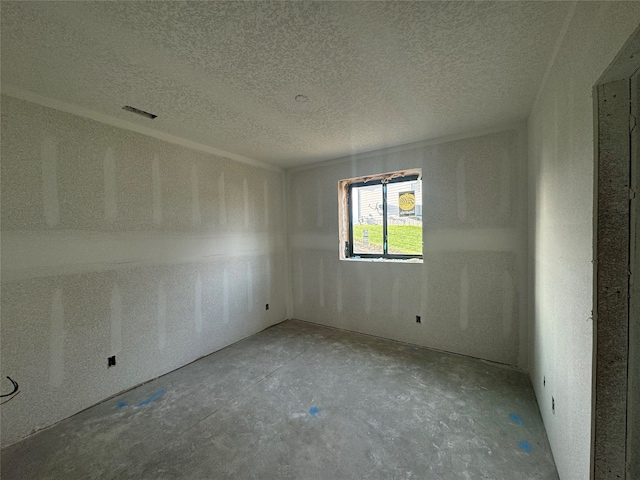 empty room featuring a textured ceiling