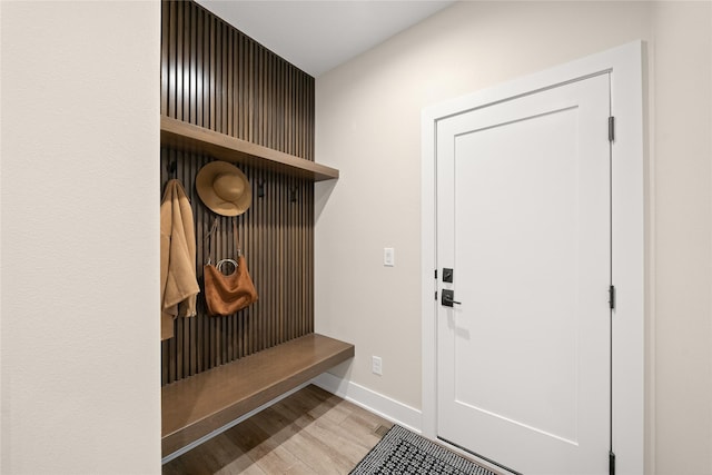 mudroom with wood finished floors and baseboards