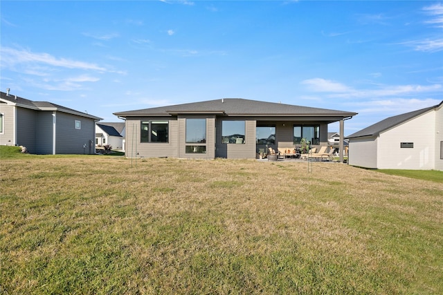 back of house featuring a patio and a yard