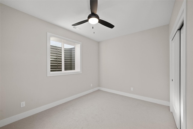 unfurnished bedroom featuring a closet, baseboards, a ceiling fan, and carpet flooring