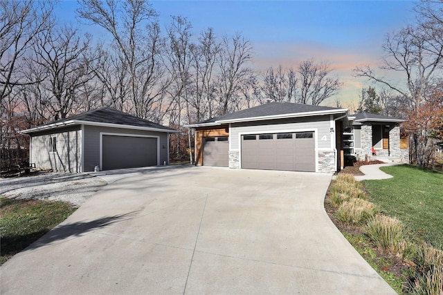 4 Ridgecrest Ln, Dallas Center, IA 50063 - view of front of property with stone siding, a front yard, concrete driveway, and a detached garage