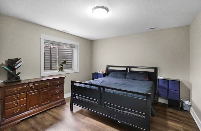 bedroom with dark wood-type flooring