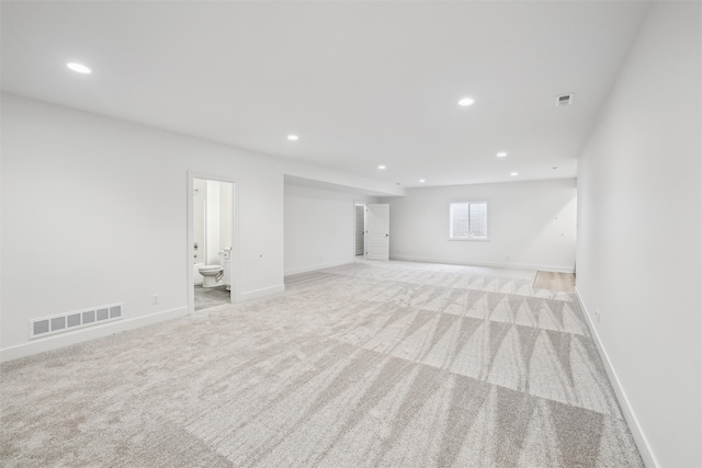 basement featuring light colored carpet