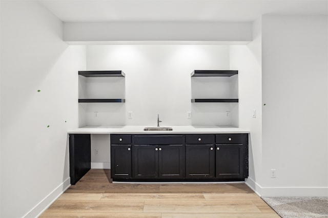 bar featuring sink and light wood-type flooring