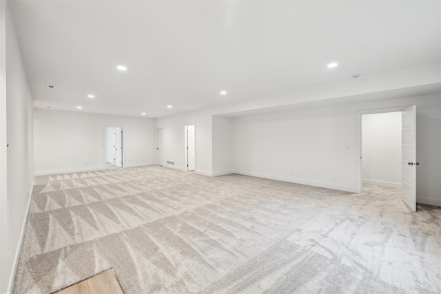 basement featuring light carpet