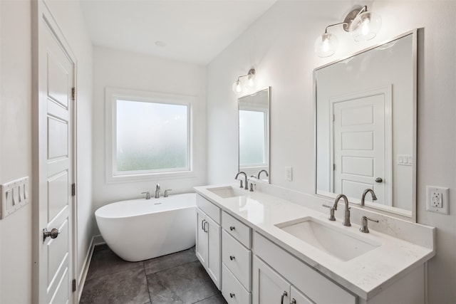 bathroom with tile patterned floors, vanity, and a bath