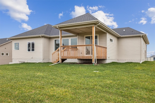 back of property featuring a lawn and a wooden deck