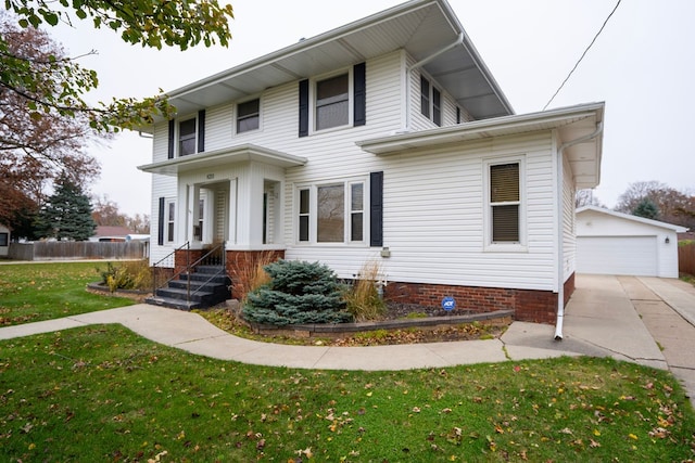 view of front of property with a front yard, an outdoor structure, and a garage