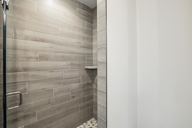 bathroom featuring a shower with door