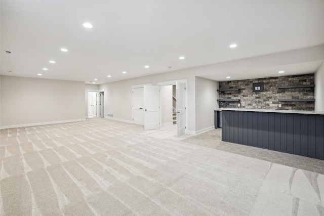 basement featuring light carpet