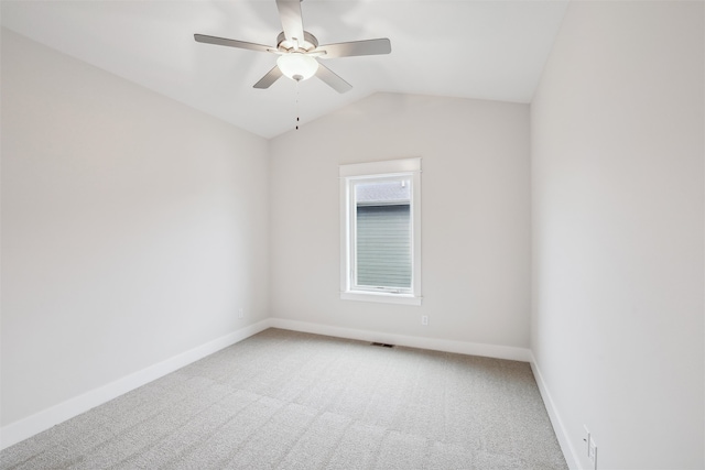 empty room with ceiling fan, carpet, and lofted ceiling