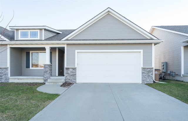 craftsman-style house featuring a front lawn and a garage