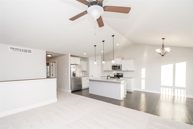 kitchen featuring stainless steel appliances, a kitchen island with sink, pendant lighting, white cabinets, and dark hardwood / wood-style floors